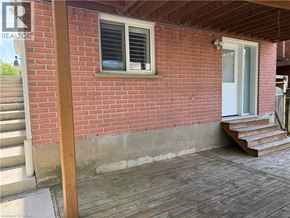 Kitchener apartment for rent - A red brick house with a white door and a window.