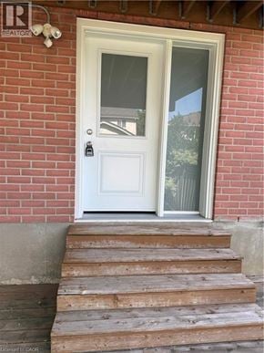 Kitchener apartment for rent - Steps leading to a white door with a glass window.
