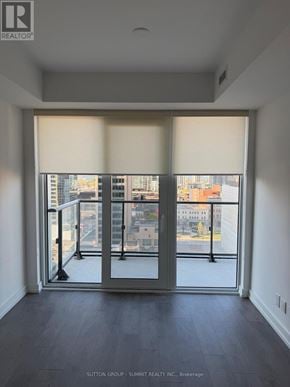 Hamilton (Corktown) condo for rent - A room with a view of the city through large windows.