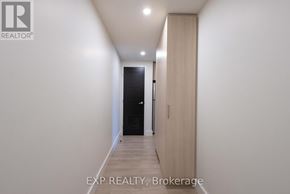 Waterloo condo for rent - A hallway with a door on the right and a light on the ceiling.