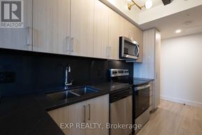 Waterloo condo for rent - A kitchen with black countertops and wooden cabinets.