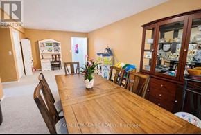 Welland (West Welland) apartment for rent - A dining room with a wooden table and chairs.