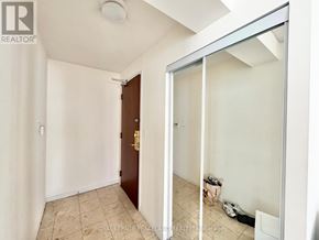Toronto (Newtonbrook East) condo for rent - A room with a door and a wall with a mirror.