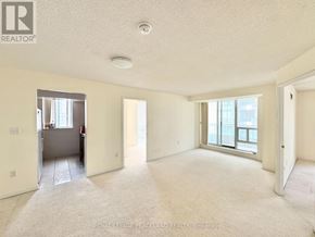 Toronto (Newtonbrook East) condo for rent - A spacious, empty room with a carpeted floor and large windows.