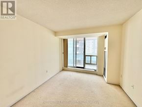 Toronto (Newtonbrook East) condo for rent - A room with a carpet floor and a window with a view of a building outside.