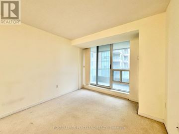 Toronto (Newtonbrook East) condo for rent - A kitchen with wooden cabinets and a white fridge.