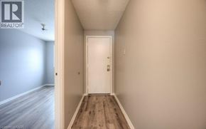 Kitchener townhouse for rent - A hallway with a white door and wooden floor.