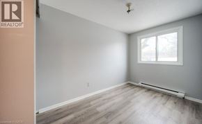 Kitchener townhouse for rent - A room with a window and a wooden floor.
