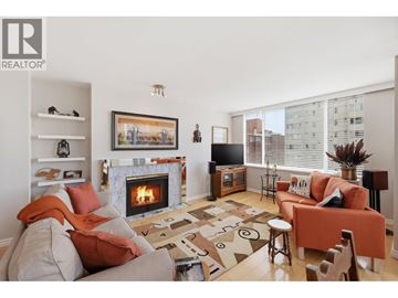 Vancouver apartment for rent - A living room with a fireplace and a painting on the wall.