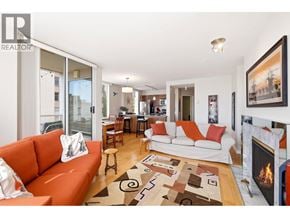 Vancouver apartment for rent - A living room with a fireplace and a couch.