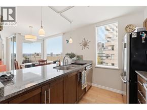 Vancouver apartment for rent - A kitchen with a black fridge and wooden cabinets.