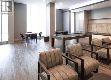 Toronto (Tam O'shanter-Sullivan) condo for rent - A living room with a pool table and a dining table.