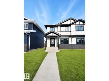 Morinville duplex for rent - A modern house with a black and white facade and a grey front door.