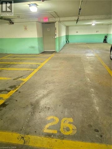 Stoney Creek condo for rent - A parking garage with the number 26 painted on the ground.