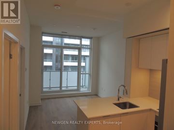 Toronto (Regent Park) condo for rent - A kitchen with a sink and a window overlooking a balcony.