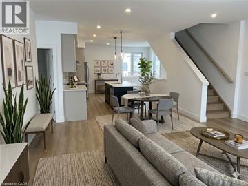 London townhouse for rent - A living room with a grey sofa and a dining table with chairs.