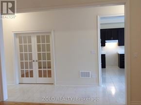 Bradford West Gwillimbury (Bradford) apartment for rent - A white interior room with a door and a window.
