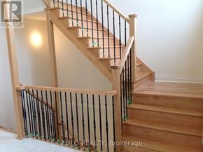 Bradford West Gwillimbury (Bradford) apartment for rent - A wooden staircase with a black railing.