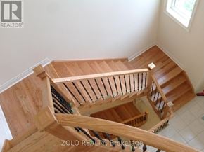 Bradford West Gwillimbury (Bradford) apartment for rent - A wooden staircase with a railing and a window.