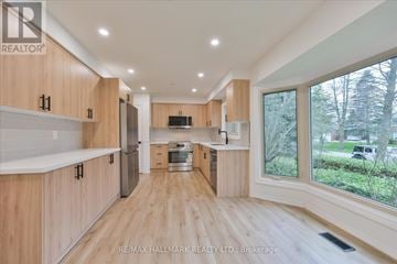 King (King City) apartment for rent - A spacious kitchen with wooden cabinets and a central island.