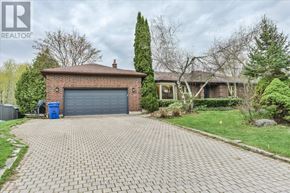 King (King City) apartment for rent - A house with a grey garage door and a brick driveway.