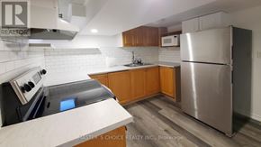 Richmond Hill (Crosby) apartment for rent - A kitchen with a refrigerator, microwave, and oven.