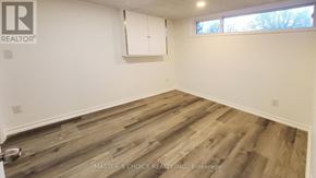 Richmond Hill (Crosby) apartment for rent - A room with wooden flooring and a white wall with a window.