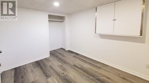 Richmond Hill (Crosby) apartment for rent - A room with a wooden floor and white walls, with a cabinet and a light fixture.