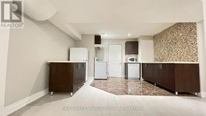Aurora apartment for rent - A kitchen with white appliances and brown cabinets.