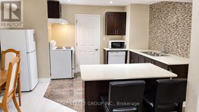 Aurora apartment for rent - A kitchen with a white fridge, microwave, and oven.