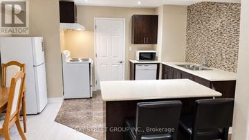 Aurora apartment for rent - A kitchen with a white fridge, microwave, and oven.