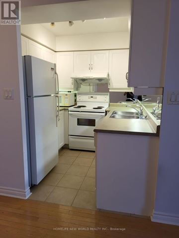 Toronto (Bayview Village) condo for rent - A kitchen with white appliances and cabinets.