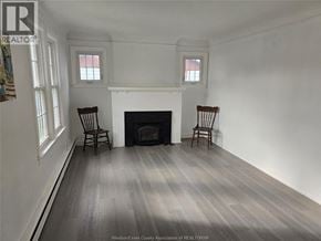 Windsor apartment for rent - A room with a fireplace and two chairs.