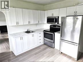 Windsor apartment for rent - A kitchen with white cabinets and a stainless steel refrigerator.