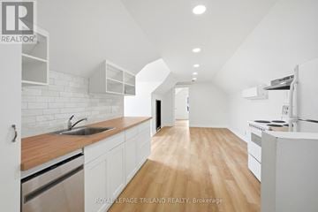 London East (East L) duplex for rent - A modern kitchen with white cabinets and a wooden countertop.