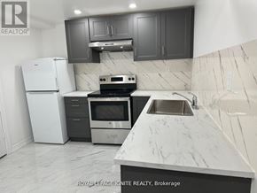 Toronto (Rouge) apartment for rent - A kitchen with a white refrigerator, stove, and sink.