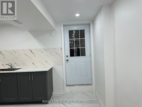 Toronto (Rouge) apartment for rent - A white door with a glass window is in a room with white walls.