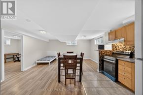 Barrie (East Bayfield) apartment for rent - A kitchen with a table and chairs in the middle of the room.