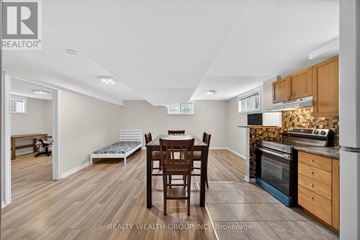 Barrie (East Bayfield) apartment for rent - A kitchen with a table and chairs in the middle of the room.