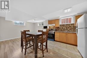 Barrie (East Bayfield) apartment for rent - A kitchen with a table and chairs in the middle of the room.
