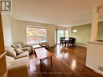London North (North M) apartment for rent - A living room with a couch, a table, and a dining table.