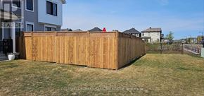 Ottawa apartment for rent - A wooden fence in front of a house.