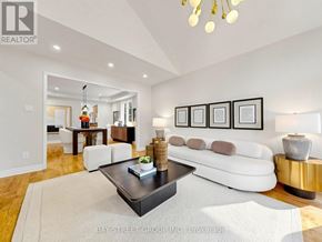 Aurora (Aurora Highlands) apartment for rent - A living room with a white couch, a coffee table, and a chandelier.