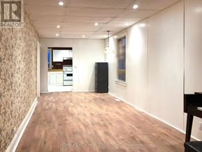 Toronto (Rockcliffe-Smythe) apartment for rent - A room with a wooden floor and a wallpapered wall.