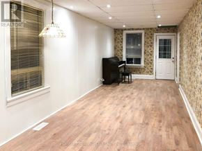 Toronto (Rockcliffe-Smythe) apartment for rent - A room with a wooden floor, a piano, and a window with blinds.