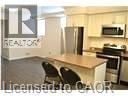 Kitchener townhouse for rent - A kitchen with a counter and a refrigerator.