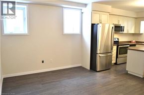 Kitchener townhouse for rent - A kitchen with a refrigerator, microwave, and oven.
