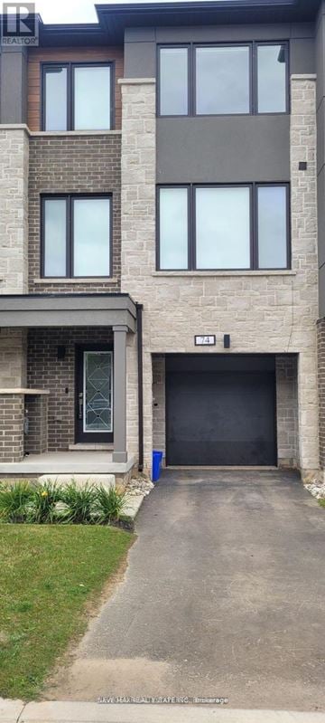 Halton Hills (Georgetown) townhouse for rent - A modern two-story building with a garage door.