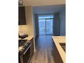 Vancouver apartment for rent - A kitchen with a stove top oven and a sink.