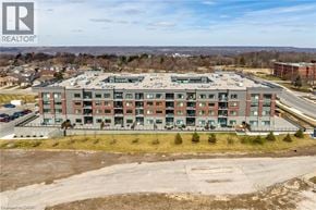 Hamilton condo for rent - A large building with a parking lot in front of it.